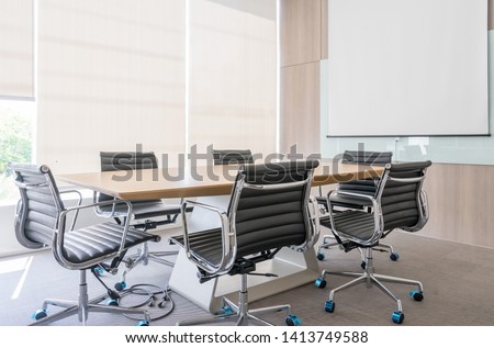 Modern meeting room with projection screen and conference table