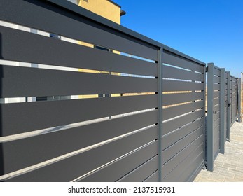 Modern Metal Fence For Fencing The Yard Area. Horizontal Sections Of The Fence Made Of Metal