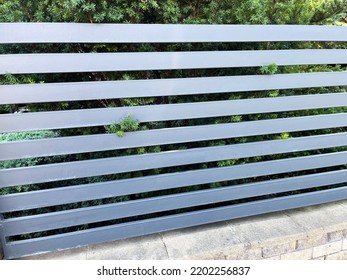 Modern Metal Fence For Fencing The Yard Area. Horizontal Sections Of The Fence Made Of Metal	