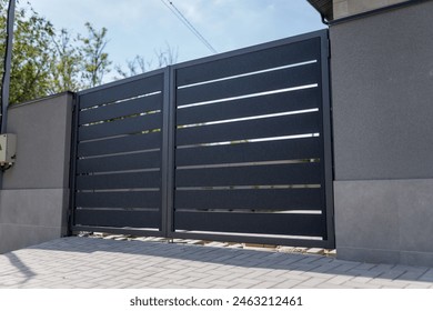 Modern metal fence for fencing the yard area. Horizontal sections of the fence made of metal