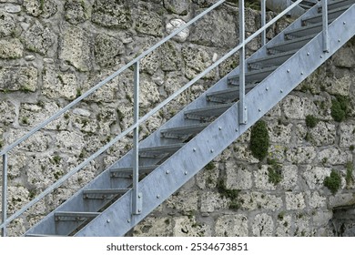 Modern metal staircase close-up against the background of an ancient building.  - Powered by Shutterstock