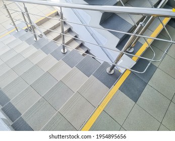 Modern Metal Staircase.Looking Down At A Modern Staircase With White Wall As To Be Found In An Office, Hospital Or An Apartment.sunny Day.yellow Line Helps Visually Impaired The Indoor Stairway