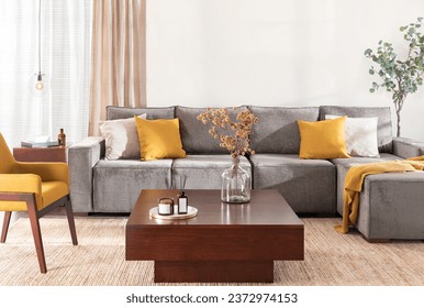 Modern Mid-Century Living Room Featuring a Large Grey Sectional Sofa with Chaise Lounge, Yellow Fabric Accent Armchair, Modern Wooden Square Storage Coffee Table, Area Rug, and Window with Curtains.