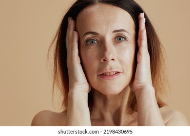 Modern Middle Aged Woman With Short Hair Isolated On Beige.