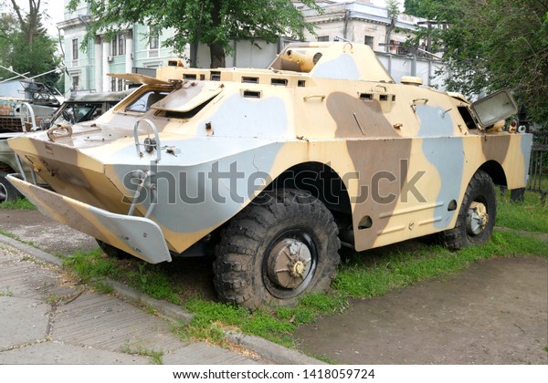 modern\
military armored car with camouflage\
coloring