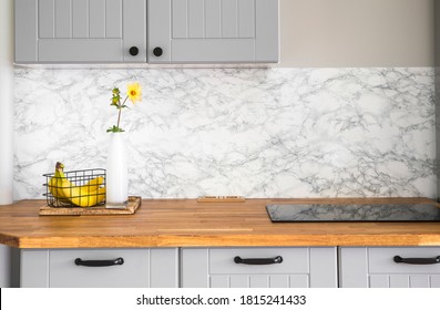 Modern Minimal Gray Color Kitchen With Self Adhesive Fake Marble Imitation Tape On Wall, Solid Natural Wood Countertop With Built In Small Stove.