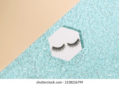 Modern Minimal Summer Makeup Concept With Black Fake Eyelashes On Blue Beach Water. Trendy Beauty Aesthetic.