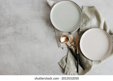 Modern Minimal Table Place Setting Neutral Beige Color On Gray Concrete Background Top View.  Space For Text .  Modern Kitchen.Scandinavian Style Tableware.Business Food Brand Template.