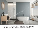 Modern minimalist bathroom interior, modern bathroom cabinet, white sink, wooden vanity, interior plants, bathroom accessories, bathtub and shower, white and blue walls, concrete floor.