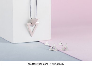 Modern minimalist geometric silver earring on pink background. Triangle shape earrings. Product concept for jeweler - Powered by Shutterstock