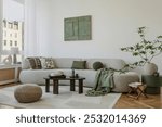 A modern, minimalist interior with a large sofa and natural accents. Soft greens bring harmony to the space, creating an elegant, calming atmosphere.