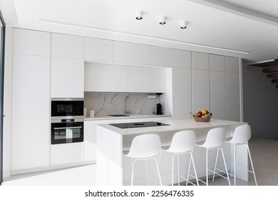 Modern minimalist marble white kitchen, minimalist interior design. Modern furniture with accessories and various utensils, table and chairs in the dining room.concept of modern and white kitchen. - Powered by Shutterstock