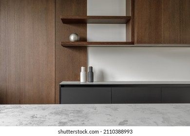 Modern minimalistic kitchen with black and wooden surfaces, marble kitchen island top and household appliances. Modern Concept For Interior Design And Architecture.