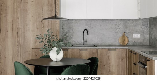 Modern minimalistic kitchen and dining room interior with wooden and white surfaces, green chairs and eucalyptus in ceramic vase. Aesthetic simple interior design concept. - Powered by Shutterstock