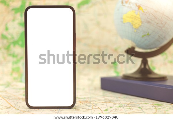 Modern mobile phone with blank\
white screen on background of the globe and city map, copy space\
