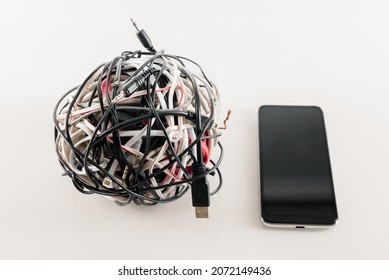 Modern Mobile Phone With Messy Bunch Of Different Cables, Future Progress Of Wireless Technology