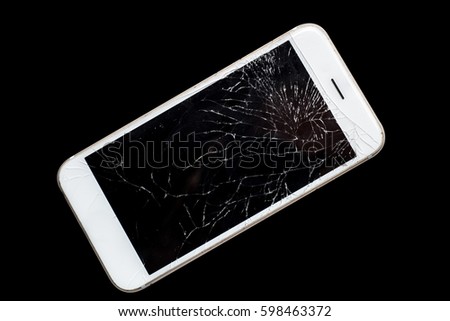 Modern mobile smart phone with broken cracked screen isolated on black background, close up.