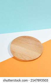 Modern mockup for food design. Empty wood plate on colourful background - Shutterstock ID 2147893503
