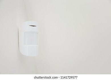 Modern motion sensor on wall indoors - Shutterstock ID 1141729577