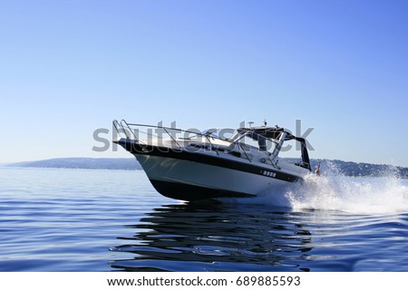Modern motorboat cruising with high speed on water