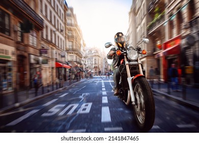 A Modern Motorcyclist Drives On A Motorcycle On The Road In The City. Selective Focus. High Quality Photo. Front View