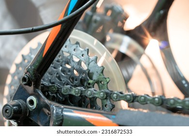 Modern mountain bike in the workshop. Bicycle repair in a professional workshop and preparation for competitions. Bicycle parts close-up. Setting up the rear derailleur