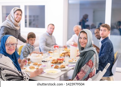 Modern Multiethnic Muslim Family Enjoying Eating Iftar Dinner Together During A Ramadan Feast At Home