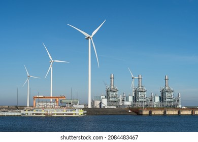 Modern multi-fuel power station and a wind turbine in a seaport.