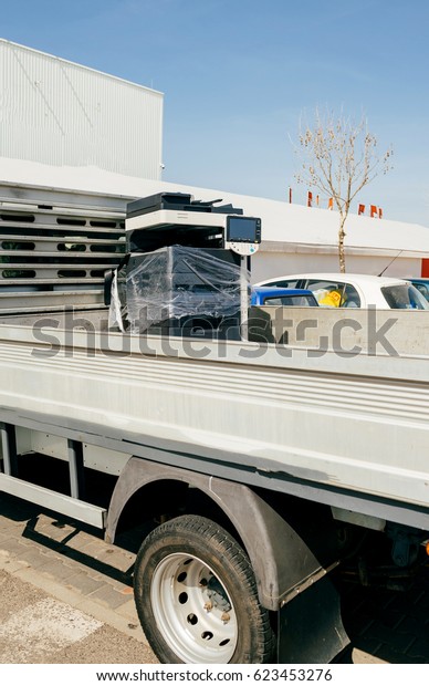 Modern multifunction copy machine in van\
trunk during office moving service\
truck