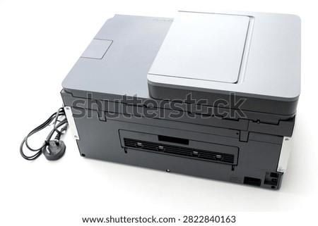 A modern multifunction printer is isolated on a clean white background