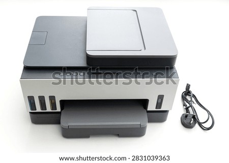 A modern multifunction printer stands on a white background