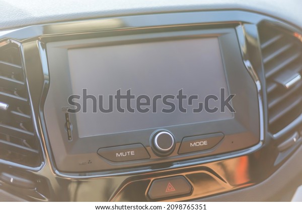 A modern\
multimedia panel with a screen and control buttons in the car\
interior. Monitor and radio in the\
car.