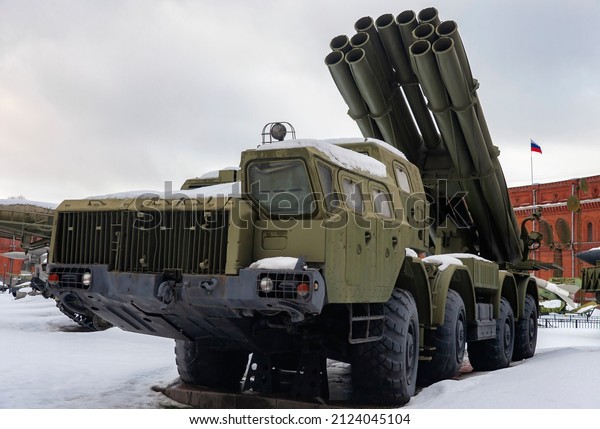 Modern multiple rocket launcher system in the parking\
lot in winter.  Powerful multi-barrel and long-range artillery\
multiple rocket launcher on a wheeled chassis in the parking lot. \
Smerch; Uragan; 