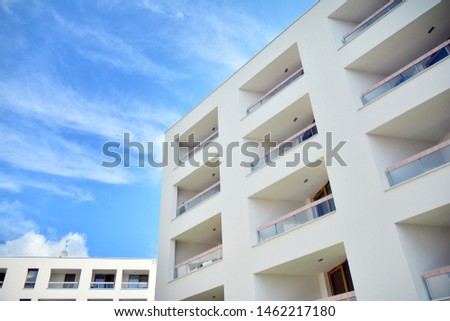 Modern multi-storey luxury housing concept. Modern apartment building with blue sky and clouds.