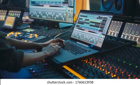 Modern Music Record Studio Control Desk with Laptop Screen Showing User Interface of Digital Audio Workstation Software. Equalizer, Mixer and Professional Equipment. Faders, Sliders. Record. Close-up - Shutterstock ID 1760613938