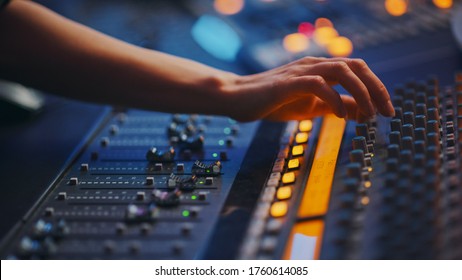 Modern Music Record Studio Control Desk with Automatic Equalizer, Mixer and other Professional Equipment. Switchers, Buttons, Faders, Sliders, Motorized Faders Move, Record, Play Hit Song. Close-up