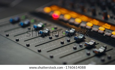 Modern Music Record Studio Control Desk with Automatic Equalizer, Mixer and other Professional Equipment. Switchers, Buttons, Faders, Sliders, Motorized Faders Move, Record, Play Hit Song. Close-up