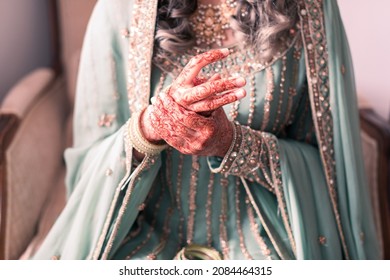 Modern Muslim Pakistani Bride Prepares For Nikkah Ceremony By Putting On Traditional Bangles 