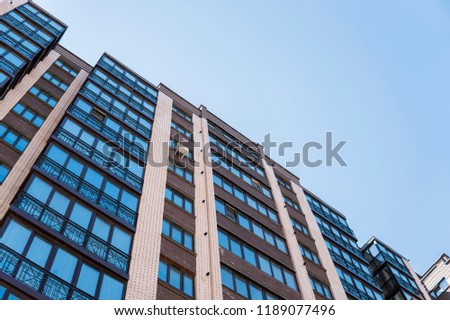 Modern and new apartment building. Multistoried, modern, new and stylish living block of flats. Real estate. New house. Newly built block of flats.