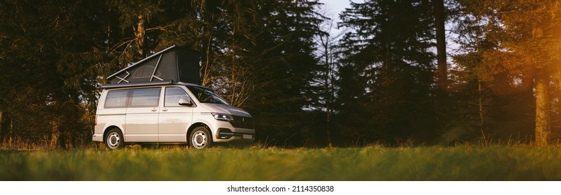 Modern new Camping Van parking at the forest in beautiful, authentic nature. 