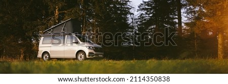 Modern new Camping Van parking at the forest in beautiful, authentic nature. 