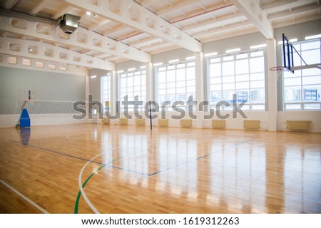 Modern new school building. Empty school gymnasium with yellow floor and climbing near walls