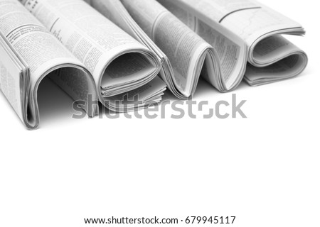 Modern newspapers are folded and composing together the word NEWS, isolated over white background. Concept of business news, news media, print media and mass media at all. Copy space for your text