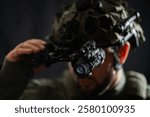 Modern night vision binocular mounted on a military tactical helmet, close-up photo.