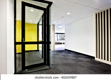 Modern Office Or Apartment Area Through The Hallway With Glass Doors Opened And Lights On