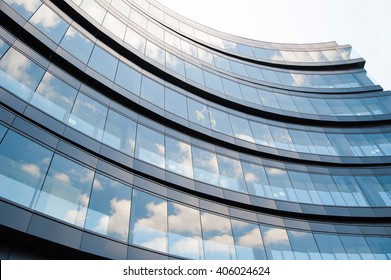 Modern Office Architecture. Close-up of glass facades of office building with sky reflection