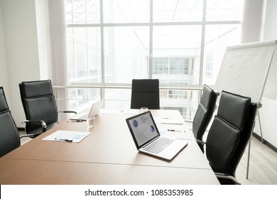 Modern Office Boardroom Interior With Laptops Documents On Conference Table And Big Window, Empty Company Meeting Room With No People After Corporate Group Briefing, Business Real Estate For Rent