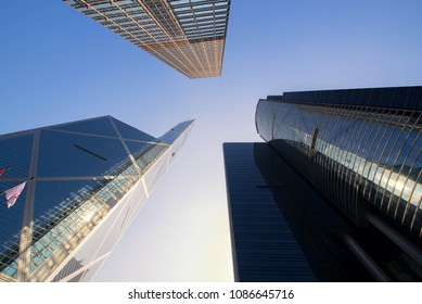 Modern Office Building.low Angle View Of Skyscrapers In City Of Hongkong. Silhouette Bird Over The Sky..Panoramic And Perspective View Business Concept Of Success Industry Tech Architecture.
