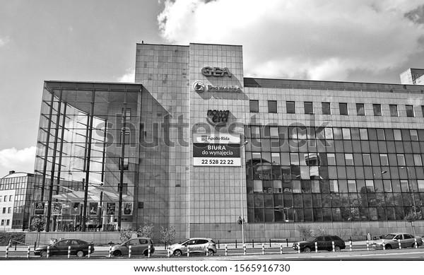 Modern office building. Company\
offers office space. Urban landscape. City Business District. Black\
and White Photography. Traffic. Poland, Warsaw – April 24, 2018\
