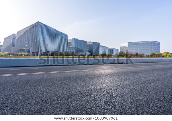 modern office building with empty asphalt road in\
shanghai china